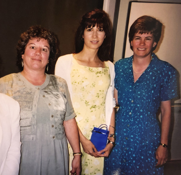 Three women pose for a photo