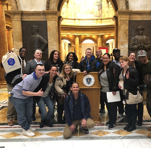 People posed at a podium in a nice building