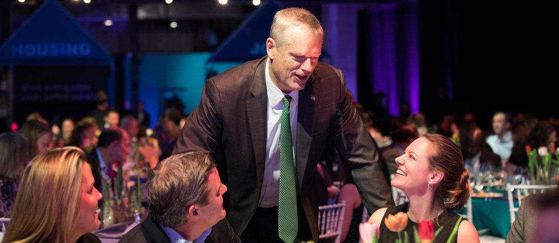 Governor Baker leaning over to talk with guests at our open door gala