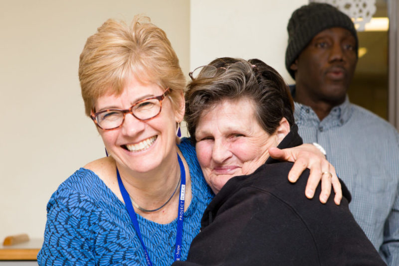 Suzanne and a client of Gatehouse hugging
